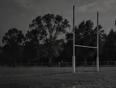 Junior rugby league players on the field at sunset